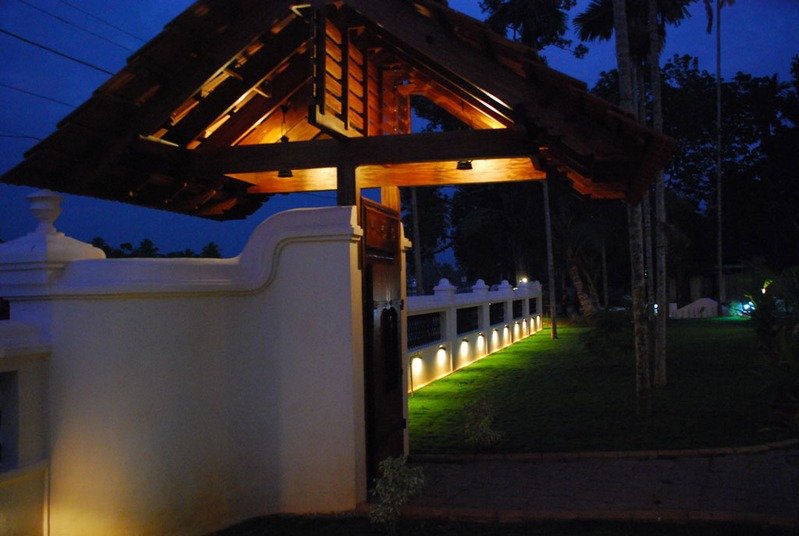 Dusk lamps along the heritage wall.
